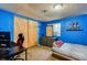 Bright blue bedroom featuring a closet, dresser, bed, and desk for a cozy and functional space at 3035 S Biscay St, Aurora, CO 80013