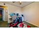 Bedroom features a work station with chair, overhead fan, and a modern area rug at 3035 S Biscay St, Aurora, CO 80013