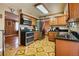 Well-equipped kitchen with stainless steel appliances, wooden cabinets, and unique patterned flooring at 3035 S Biscay St, Aurora, CO 80013