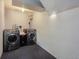 Well-equipped laundry room featuring a washer and dryer set, offering convenience and efficiency at 3035 S Biscay St, Aurora, CO 80013