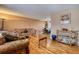 Comfortable living room with hardwood floors, furniture set, and a view of the dining room beyond at 3035 S Biscay St, Aurora, CO 80013