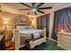 Serene bedroom featuring a large bed, ornate headboard, soft lighting, and elegant window treatments at 3035 S Biscay St, Aurora, CO 80013