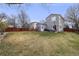 Spacious backyard with grass area, fenced perimeter, seating and BBQ grill at 1495 Hummingbird Cir, Brighton, CO 80601