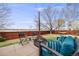 Backyard with a fire pit, a seating area and privacy fence at 1495 Hummingbird Cir, Brighton, CO 80601