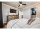Bright bedroom with a ceiling fan, closet and built-in storage at 1495 Hummingbird Cir, Brighton, CO 80601
