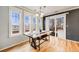Bright dining room with large windows offering scenic views and stylish table set at 1495 Hummingbird Cir, Brighton, CO 80601