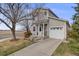 Charming two-story home with a well-maintained lawn, a single-car garage, and inviting front porch at 1495 Hummingbird Cir, Brighton, CO 80601