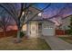 Charming two-story home with a well-maintained lawn and a single-car garage during the evening at 1495 Hummingbird Cir, Brighton, CO 80601
