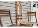 Inviting front porch featuring a rustic welcome sign, wooden chairs and a small accent table at 1495 Hummingbird Cir, Brighton, CO 80601