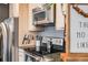 Close-up on kitchen featuring stainless appliances and modern countertops at 1495 Hummingbird Cir, Brighton, CO 80601