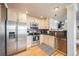 Bright kitchen featuring stainless steel appliances and modern light-colored cabinets at 1495 Hummingbird Cir, Brighton, CO 80601
