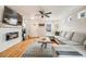 Bright living room with a modern fireplace, large gray sectional sofa, and hardwood floors at 1495 Hummingbird Cir, Brighton, CO 80601