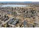 An aerial view of a residential neighborhood with a lake and mountains in the distance at 2480 Quitman St, Denver, CO 80212