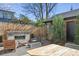 Cozy backyard seating area with a brick fireplace, perfect for outdoor entertaining at 2480 Quitman St, Denver, CO 80212