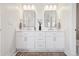 Modern bathroom features dual sinks, vanity with white cabinets, and contemporary fixtures with a decorative rug at 2480 Quitman St, Denver, CO 80212