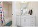 Well-lit bathroom features a shower with subway tile and a modern vanity at 2480 Quitman St, Denver, CO 80212