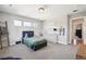 Bright bedroom features three windows, a plush bed, and ample storage space at 2480 Quitman St, Denver, CO 80212