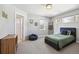 Cozy bedroom with a blue bed frame, a beanbag chair, and natural light streaming through the windows at 2480 Quitman St, Denver, CO 80212