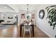 Open dining room with hardwood floors and modern lighting fixture at 2480 Quitman St, Denver, CO 80212