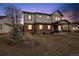 Charming two-story home with a brick facade on the first level and muted gray siding on the second at 2480 Quitman St, Denver, CO 80212