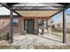 Inviting front porch with brick accents, seating, and a stylish black front door with wreath at 2480 Quitman St, Denver, CO 80212