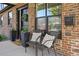 Inviting front porch features comfortable seating, decorative pillows, and a welcoming entrance at 2480 Quitman St, Denver, CO 80212
