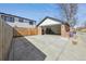 Detached brick garage with space for storage, bicycles, and a large driveway at 2480 Quitman St, Denver, CO 80212