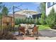 Outdoor patio area with comfortable seating under a large white umbrella, perfect for relaxation at 2480 Quitman St, Denver, CO 80212