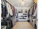 Large walk-in closet with custom shelving, ample storage, and a decorative chandelier lighting at 2480 Quitman St, Denver, CO 80212