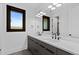 Modern bathroom featuring double sinks, contemporary fixtures, and a bright window at 8103 Raphael Ln, Littleton, CO 80125