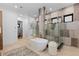 Modern bathroom with a freestanding tub and luxurious glass-enclosed shower at 8103 Raphael Ln, Littleton, CO 80125
