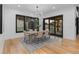 Bright dining room with contemporary chandelier and large windows allowing ample natural light at 8103 Raphael Ln, Littleton, CO 80125