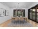Bright dining room with contemporary chandelier and large windows allowing ample natural light at 8103 Raphael Ln, Littleton, CO 80125