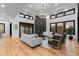 Elegant living room with high ceilings, large windows, modern fireplace, and stylish decor at 8103 Raphael Ln, Littleton, CO 80125