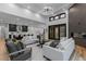 Spacious living room connecting to a kitchen, with large windows and modern furnishings at 8103 Raphael Ln, Littleton, CO 80125