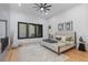 Spacious main bedroom with modern decor, large windows, and stylish accent wall at 8103 Raphael Ln, Littleton, CO 80125