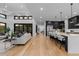 Expansive open floorplan featuring a modern kitchen, living area, and scenic outdoor views at 8103 Raphael Ln, Littleton, CO 80125