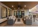 Inviting covered patio with stylish wicker furniture, ceiling fan, and views of the surrounding landscape at 8103 Raphael Ln, Littleton, CO 80125