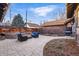 Private backyard boasts a large stone patio, wood fence, and space for outdoor entertaining at 925 Steele St, Denver, CO 80206