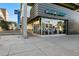 Modern commercial space with floor-to-ceiling glass windows, sleek gray exterior, and visible signage; ideal for businesses at 925 Steele St, Denver, CO 80206