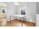 Bright dining area with a table, modern light fixture, and a view of the outdoors through a large window at 925 Steele St, Denver, CO 80206