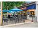 Outdoor seating area with blue umbrellas providing shade at 925 Steele St, Denver, CO 80206