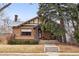 Brick home with classic architectural details and mature landscaping creating a cozy curb appeal at 925 Steele St, Denver, CO 80206