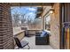 Charming front porch with brick columns provides a relaxing outdoor seating area at 925 Steele St, Denver, CO 80206