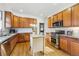 Updated kitchen featuring stainless steel appliances, granite countertops, wood cabinets, subway tile backsplash and a center island at 925 Steele St, Denver, CO 80206