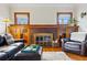 Bright living room featuring a brick fireplace, built-in cabinets, and a cozy seating arrangement at 925 Steele St, Denver, CO 80206