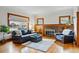 Inviting living room featuring a brick fireplace, hardwood floors, and ample natural light at 925 Steele St, Denver, CO 80206