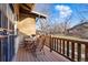 Inviting covered side porch with wooden railing features seating and faces the street at 925 Steele St, Denver, CO 80206