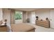 Serene bedroom with a large window, dresser, and ensuite bathroom at 3888 N Riviera Ct, Aurora, CO 80019