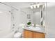Well-lit bathroom with a shower-tub combination, a vanity with sink, and a large mirror at 21069 Woodside Ln, Parker, CO 80138